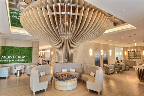 Lobby with upholstered seating beneath a wooden ceiling feature