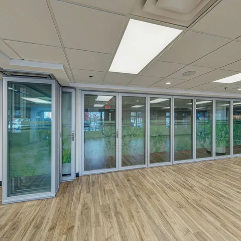 Empty room with wood flooring and glazed walls