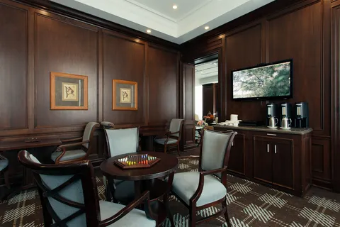 Wood-panelled pub lounge with tables and chairs.