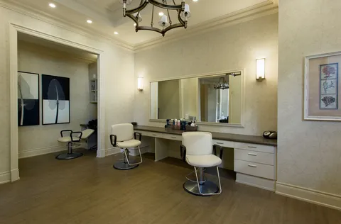 Salon with styling chairs, mirrors and cabinets.