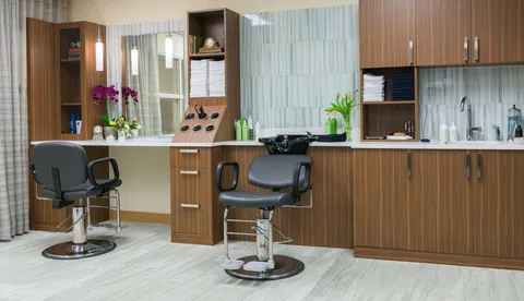 Hair salon with two styling chairs and a long counter.