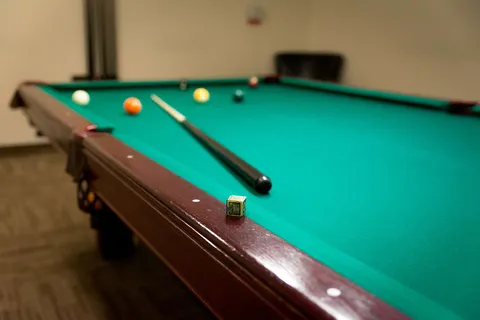 Billiard table with green felt in the games room.