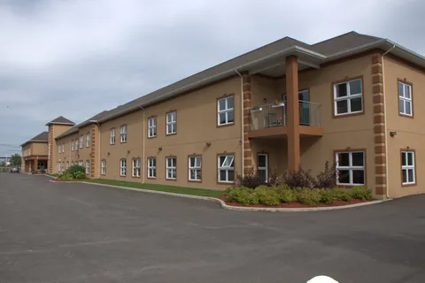 Residence building beside the paved parking area.