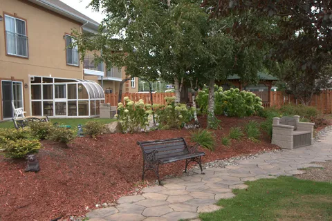 Garden path and benches beside the residence.