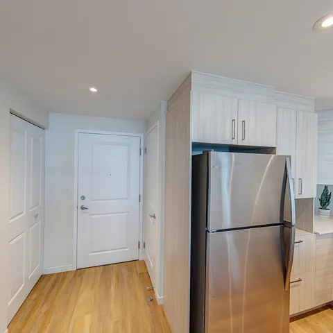Suite kitchen with white cabinets and stainless-steel appliances.