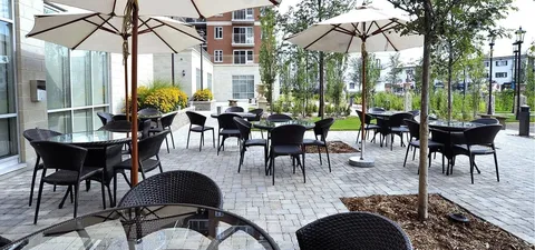 Patio with tables, wicker chairs and large umbrellas