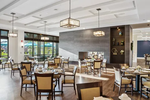 Dining room with set tables, large windows and a double-sided fireplace
