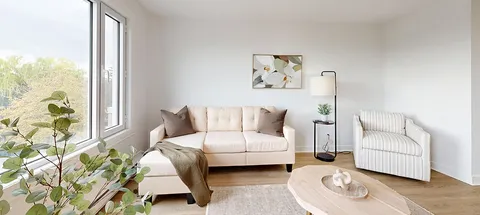 Suite sitting area with a sofa, armchair and coffee table.