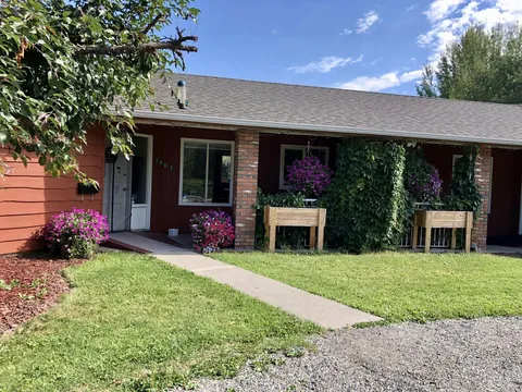 Single-storey residence with a front lawn and planted entrance.