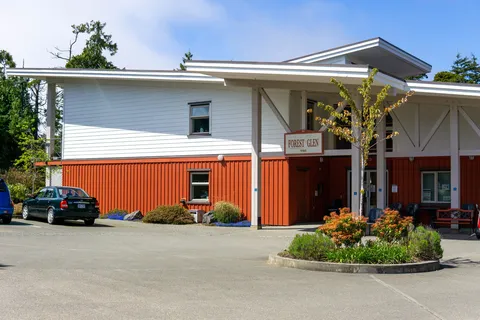 Residence facade with tall windows and a covered main entrance.