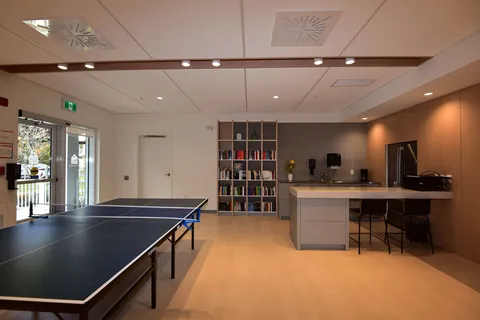 Games room with a table-tennis table and communal kitchen.