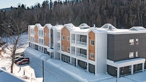 Winter view of the residence, balconies and parking area.