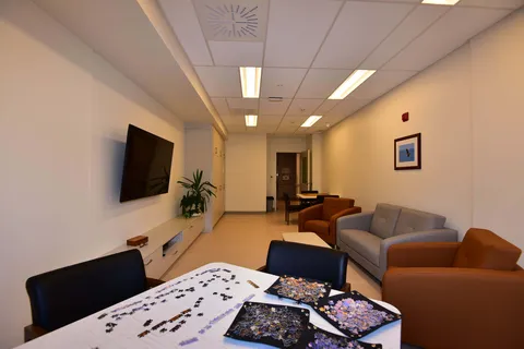 Sitting and puzzle room with sofas and a television.