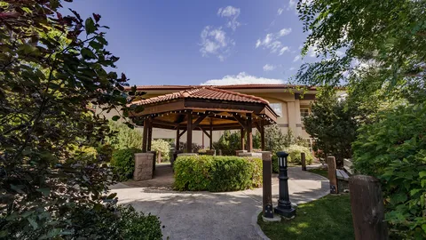 Covered garden pavilion with landscaped paths.