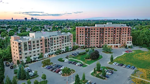 Aerial view of two residence buildings and their landscaped grounds.