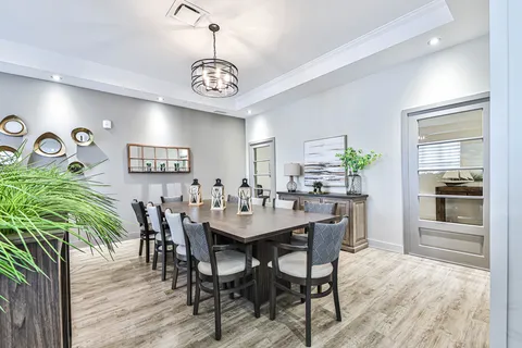 Private dining room with a table, chairs and cabinet.