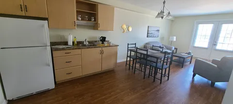 Suite with a kitchen, dining table, chairs and armchair