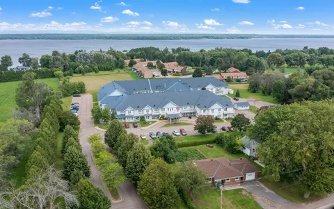Aerial view of the residence, grounds and nearby water.