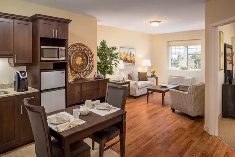 Sitting area with armchairs, a sofa and a kitchenette