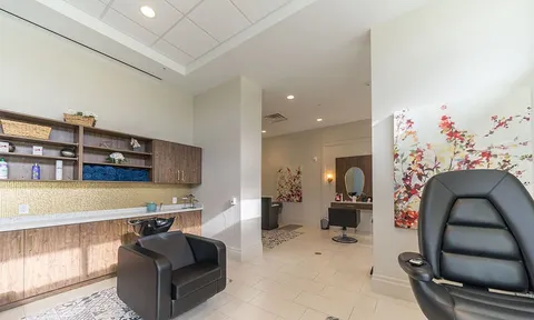 Hair salon with washbasins, styling chairs and wall mirrors.