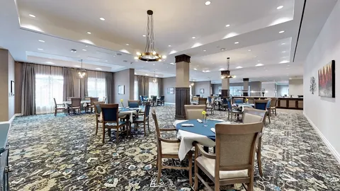 Dining room with tables, upholstered chairs and windows