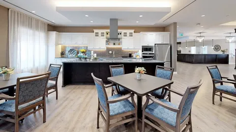Tables and blue chairs beside a kitchen counter