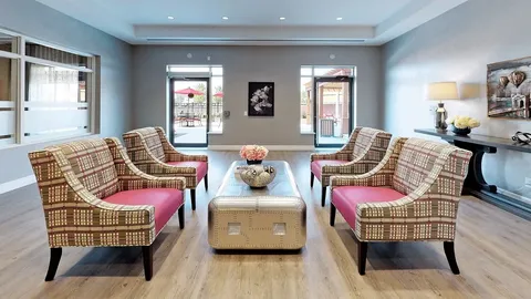 Sitting area with four patterned armchairs and a coffee table