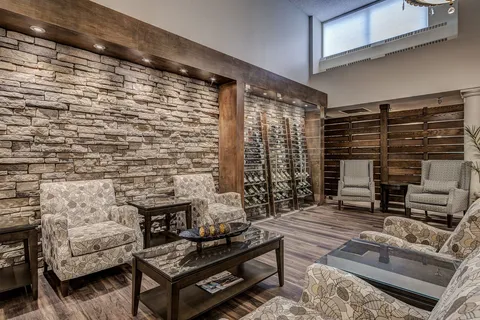 Seating area beside a stone fireplace.