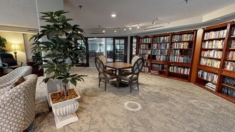 Library with bookshelves and a table.