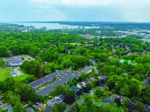 Aerial view of residence roofs among mature trees