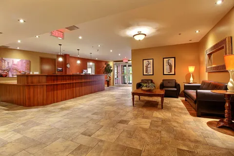 Reception lobby with a wood counter and leather seating.