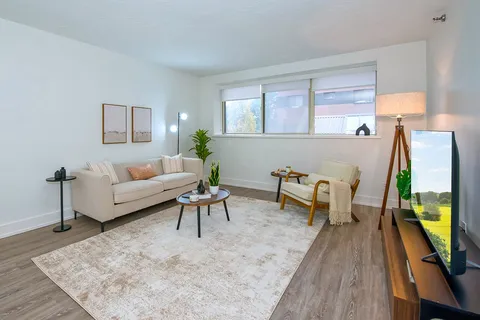Suite living room with a sofa, armchair and television