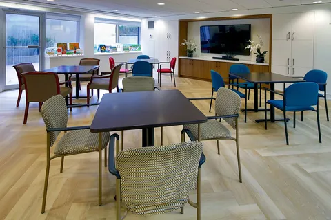 Recreation room with tables, chairs and a television