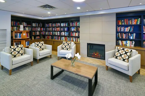 Library lounge with bookshelves and a fireplace