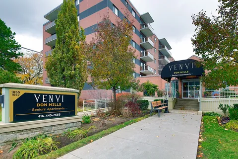 Apartment building exterior with balconies and a covered entrance