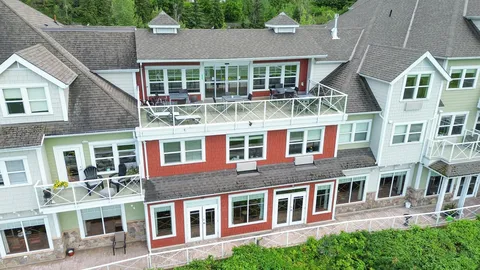 Rear of the residence building with balconies and outdoor seating.