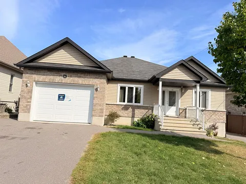 Single-storey house with front porch, garage, driveway and lawn.