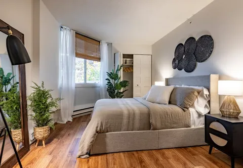 Bedroom with a bed, nightstands and window.