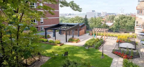 Landscaped garden paths and lawns between residence buildings.