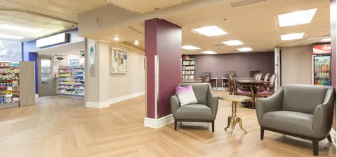 Lobby seating beside corridors and common room tables.