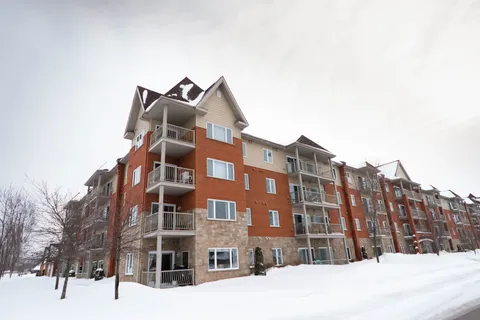 Brick residence with balconies and snow-covered grounds