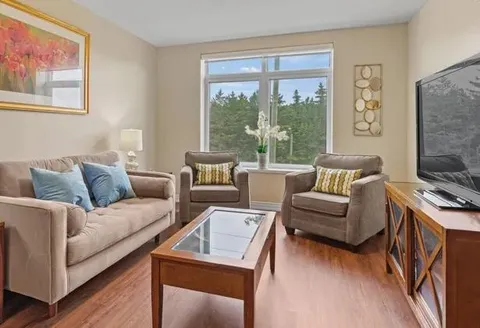Suite living room with a sofa, armchair and coffee table.