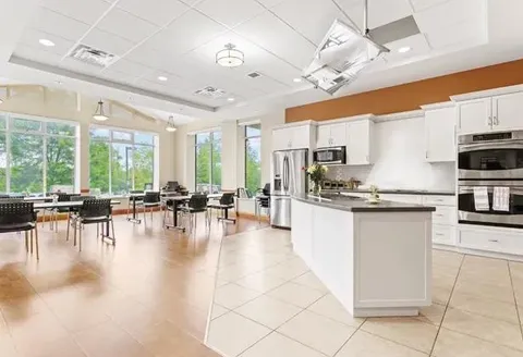 Craft kitchen with cupboards, an island and a long table.