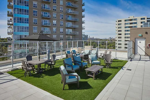 Rooftop patio with tables, chairs, umbrellas and planters