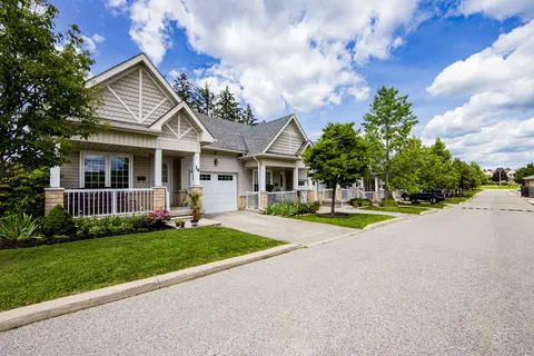 Single-storey buildings with porches and lawns beside a paved drive