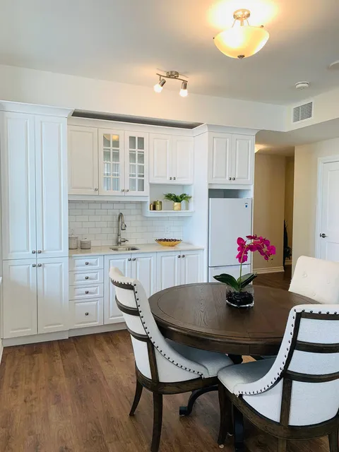 Suite kitchenette and dining table beside the living area.