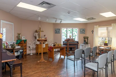 Chapel with seating, wooden furnishings and an altar.