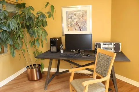 Computer station with a desk, monitor and chair.