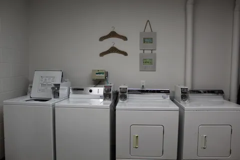 Laundry room with washing machines and dryers.