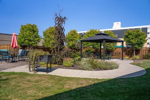 Landscaped courtyard with a gazebo, paths and patio seating.